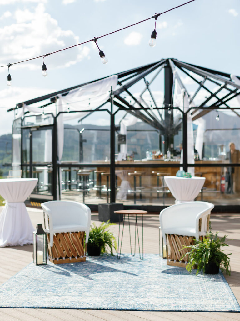 A panoramic view of the wedding reception, set against a picturesque mountain backdrop.