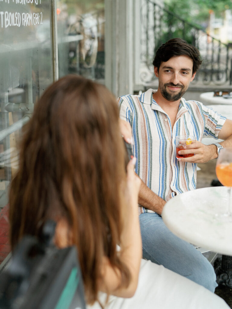Couple seated at Babas on Cannon during a Charleston engagement session