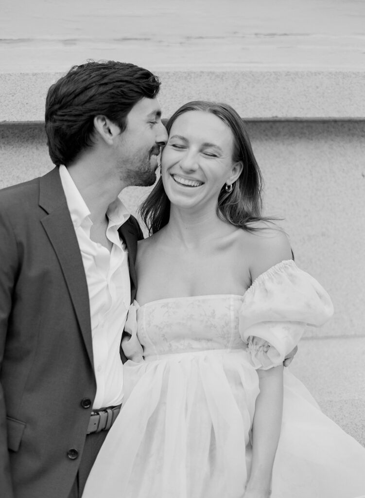 Candid engagement photos in downtown Charleston with historic architecture