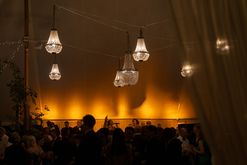 night reception under tent with chandeliers at Connecticut wedding