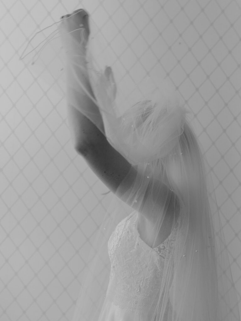bride lifting veil above her head getting ready for her wedding