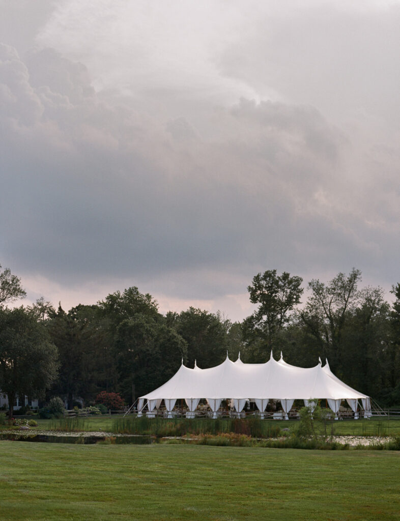sailcloth tent set on lawn at Connecticut private estate wedding