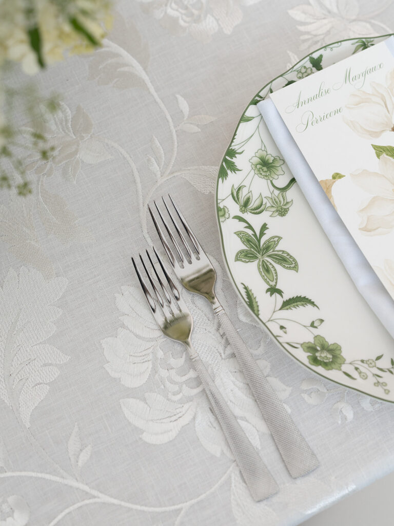 place setting with menu and patterned plate at wedding reception