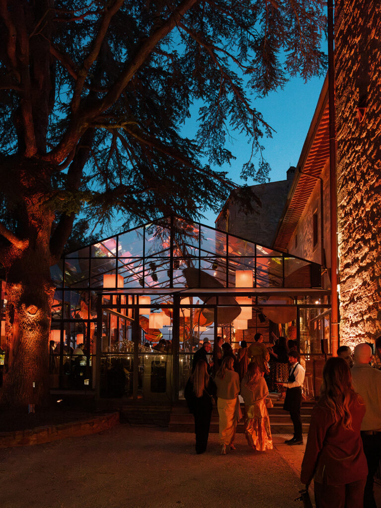 Guests arriving at glass reception structure during Engage Summit Tuscany