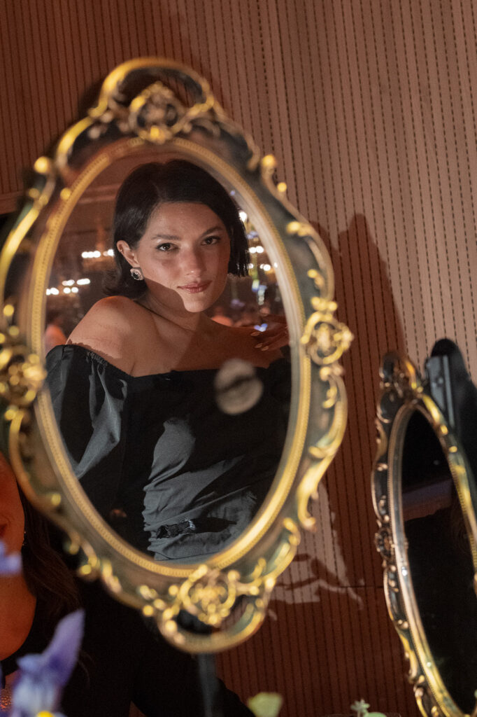 Portrait reflected in mirror at Engage Summit Tuscany gala