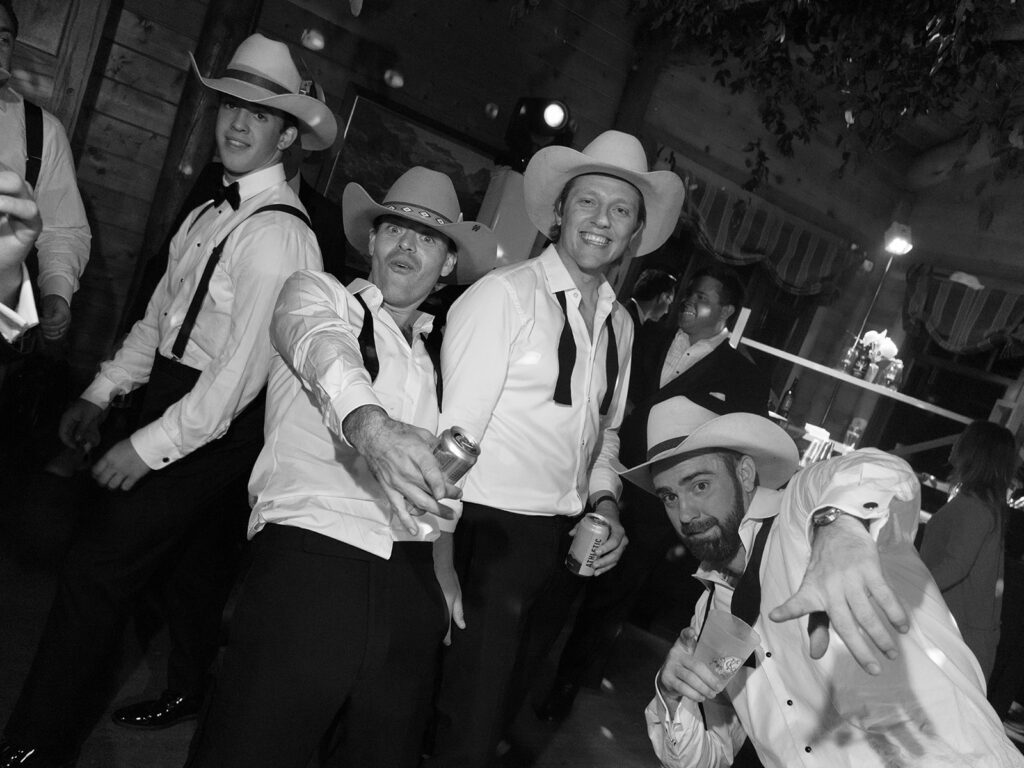 guests dancing in cowboy hats at Montana ranch wedding reception