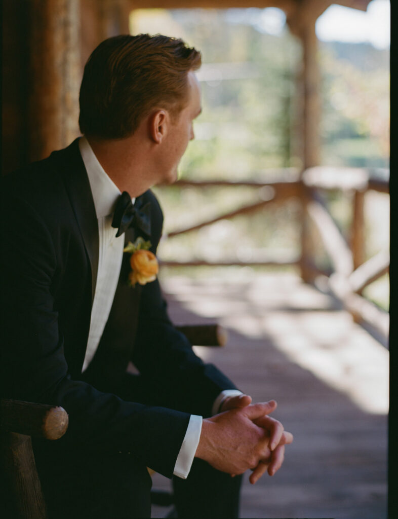 groom portrait on porch at Mountain Sky Guest Ranch wedding