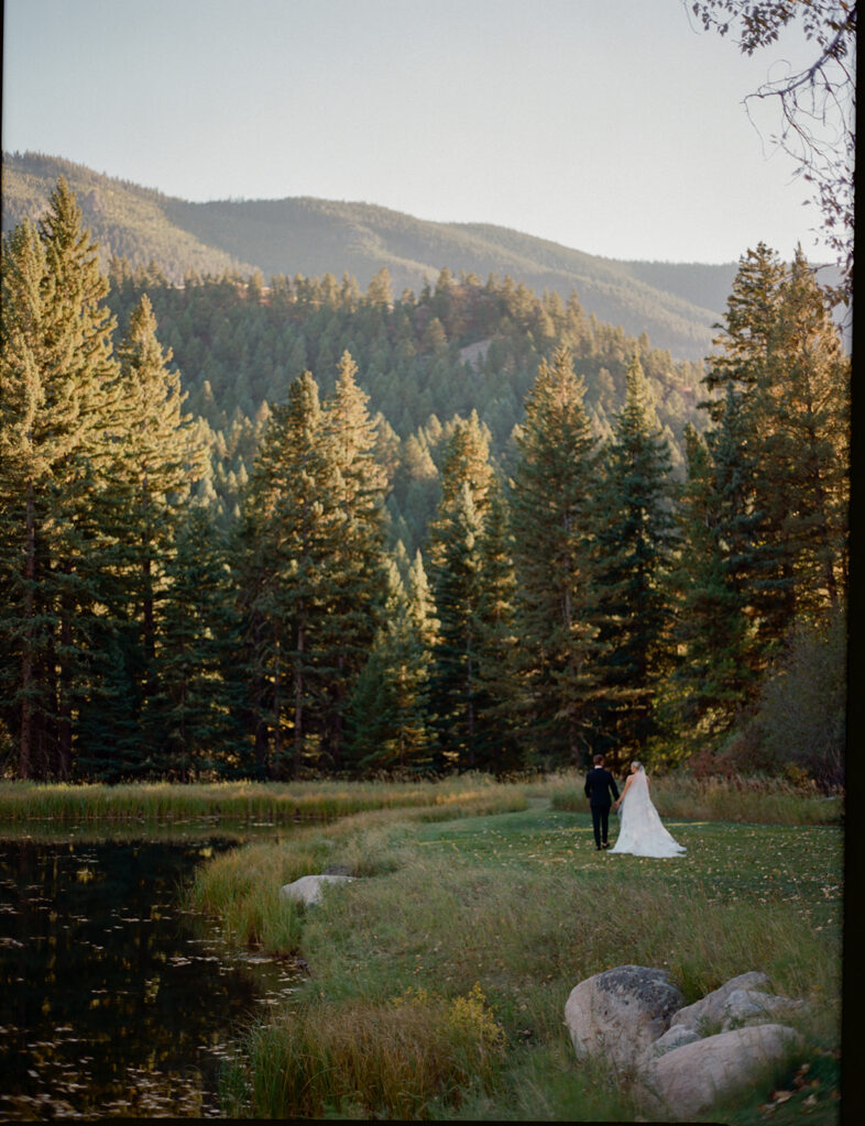 couple walking through Montana landscape at Mountain Sky Guest Ranch