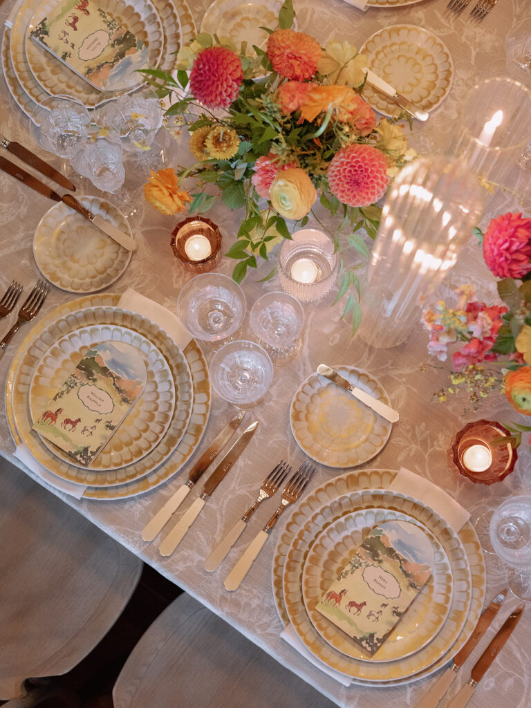 table design with florals and patterned plates at Montana ranch wedding