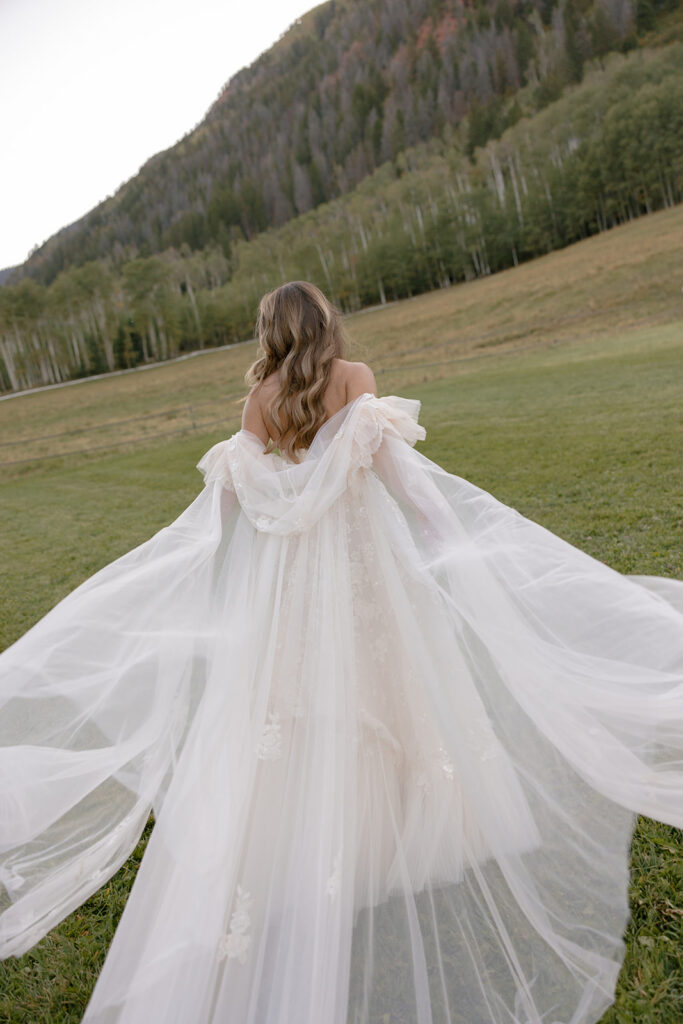 bride with flowing veil in Aspen Colorado mountains