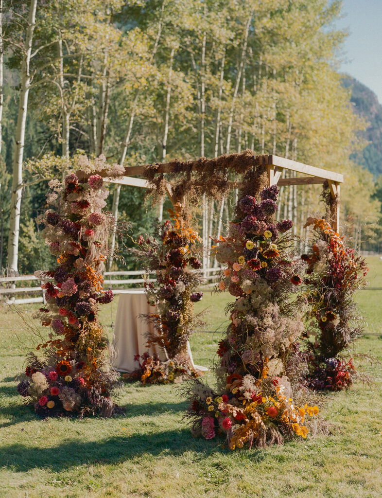 fall floral ceremony arch at Aspen Colorado wedding