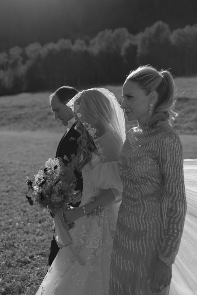bride walking down aisle at Aspen outdoor wedding ceremony
