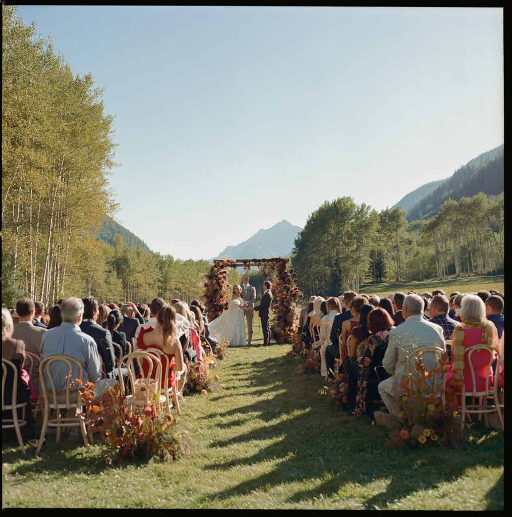 Aspen wedding ceremony with mountains and fall trees