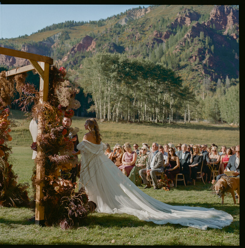 guests seated at Aspen wedding ceremony with mountain backdrop