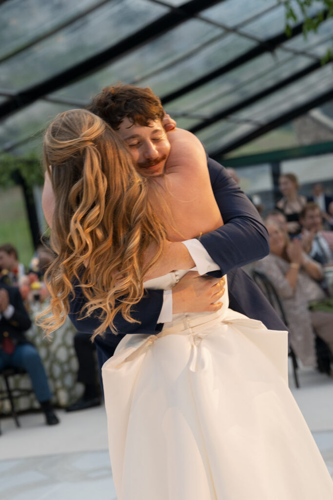 bride and groom hugging during first dance Colorado wedding