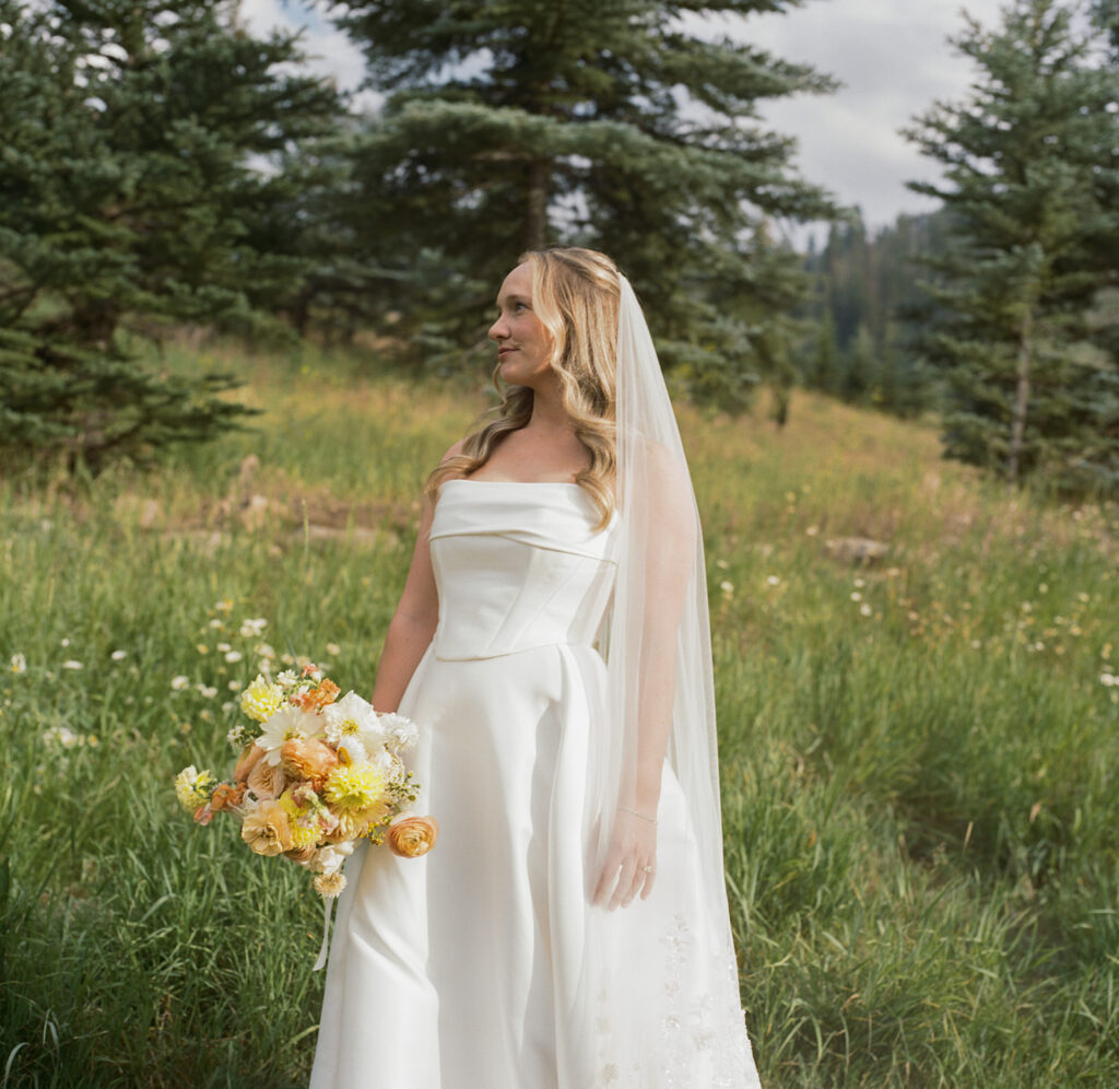 bride holding bouquet in meadow at Park Hyatt Beaver Creek wedding