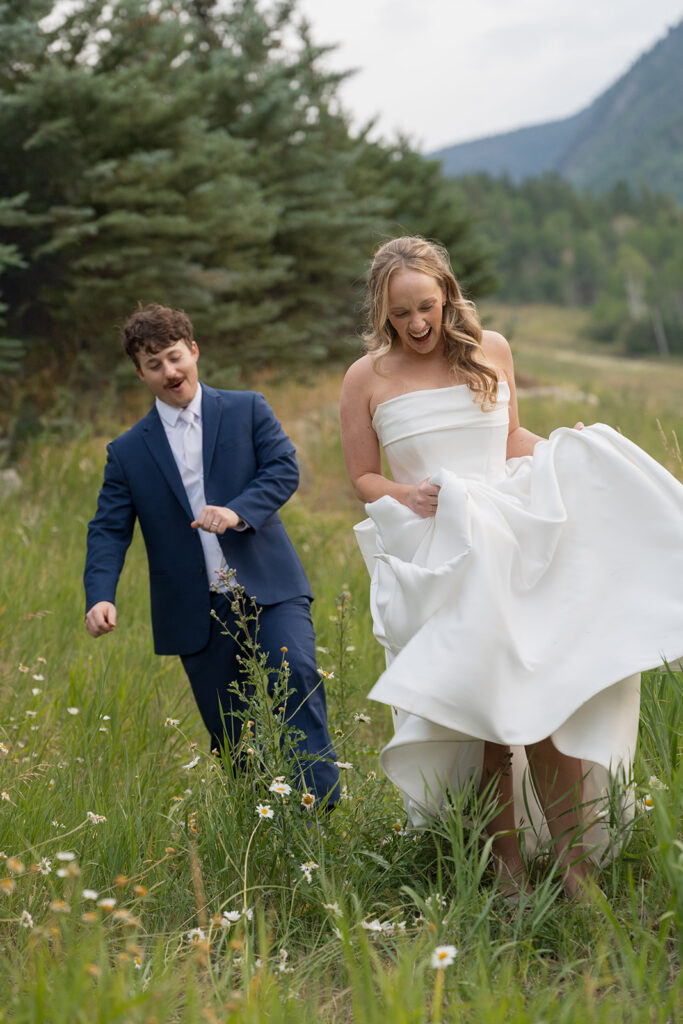 couple walking through field at Park Hyatt Beaver Creek wedding