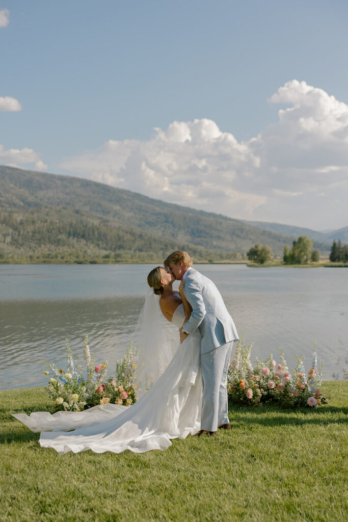 couple first kiss at lakeside ceremony in Steamboat Springs