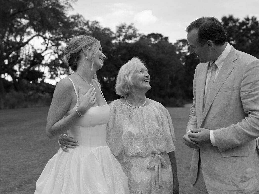 black and white family candid moment with bride, groom and grandma