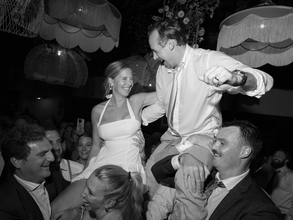 couple lifted during dance floor at Charleston wedding