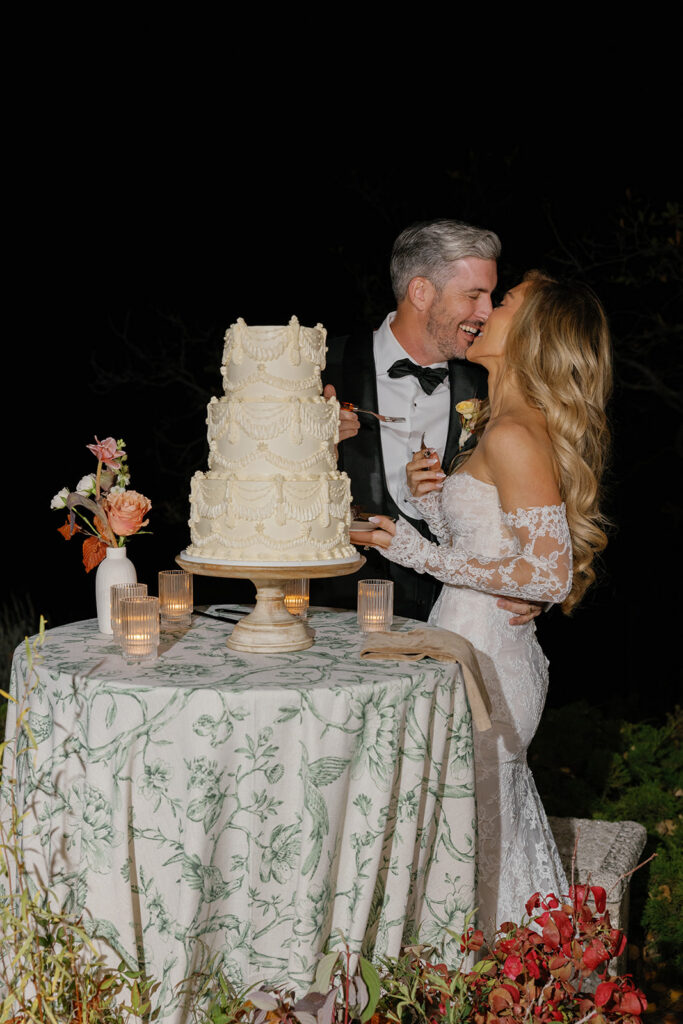 Couple cutting cake at Aspen outdoor wedding at night