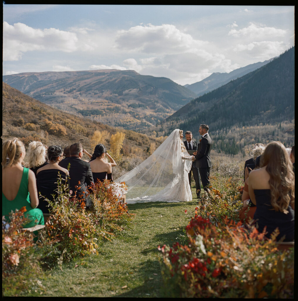 Guests seated at Aspen wedding ceremony with mountain backdrop