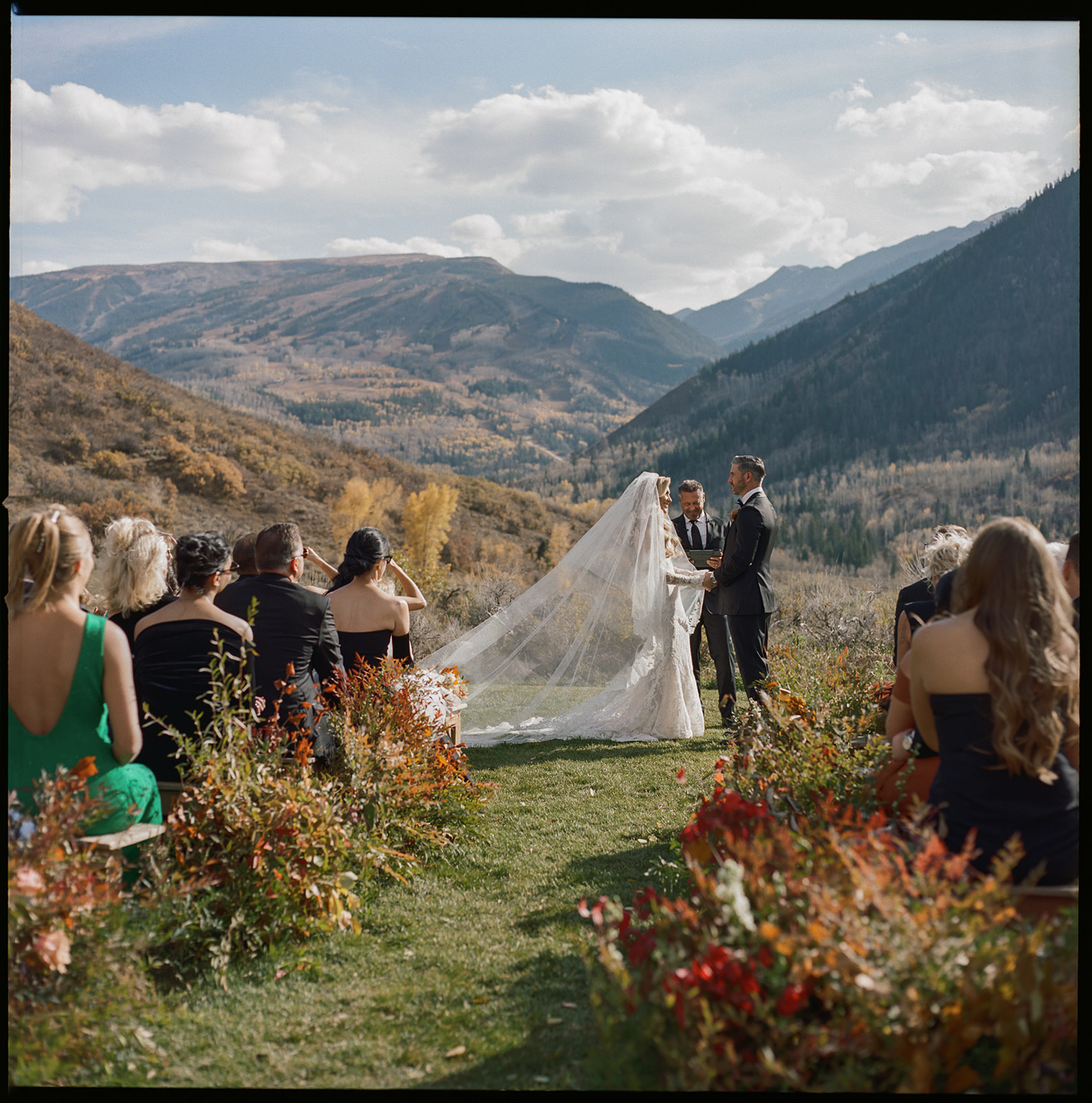 Guests seated at Aspen wedding ceremony with mountain backdrop