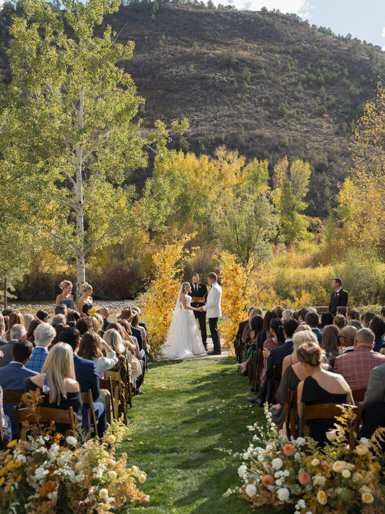 outdoor ceremony by river at Aspen private residence wedding