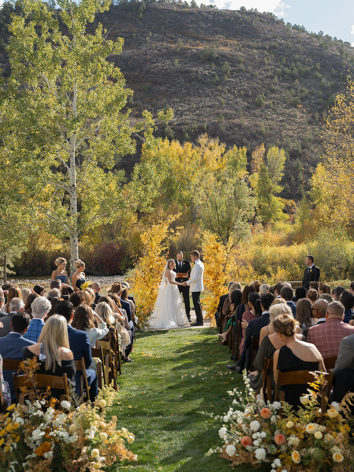 outdoor ceremony by river at Aspen private residence wedding