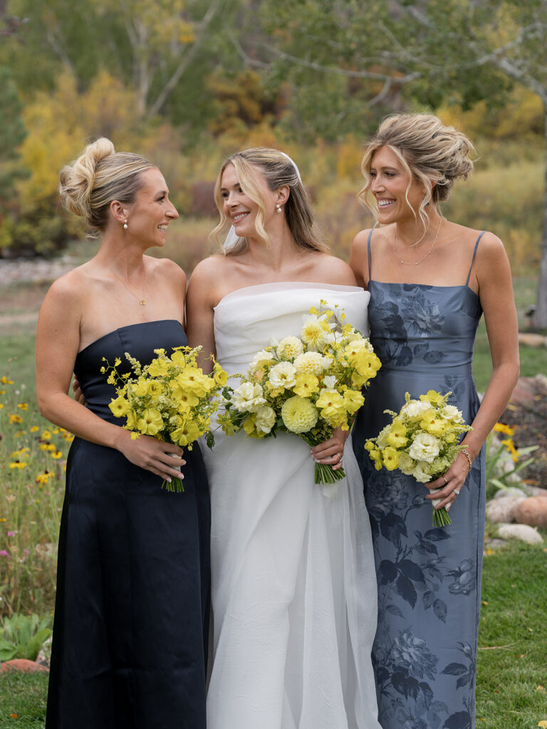 bridesmaids holding yellow bouquets at Aspen wedding