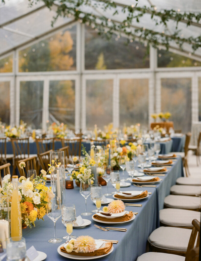 reception tables with blue linens and florals Aspen wedding