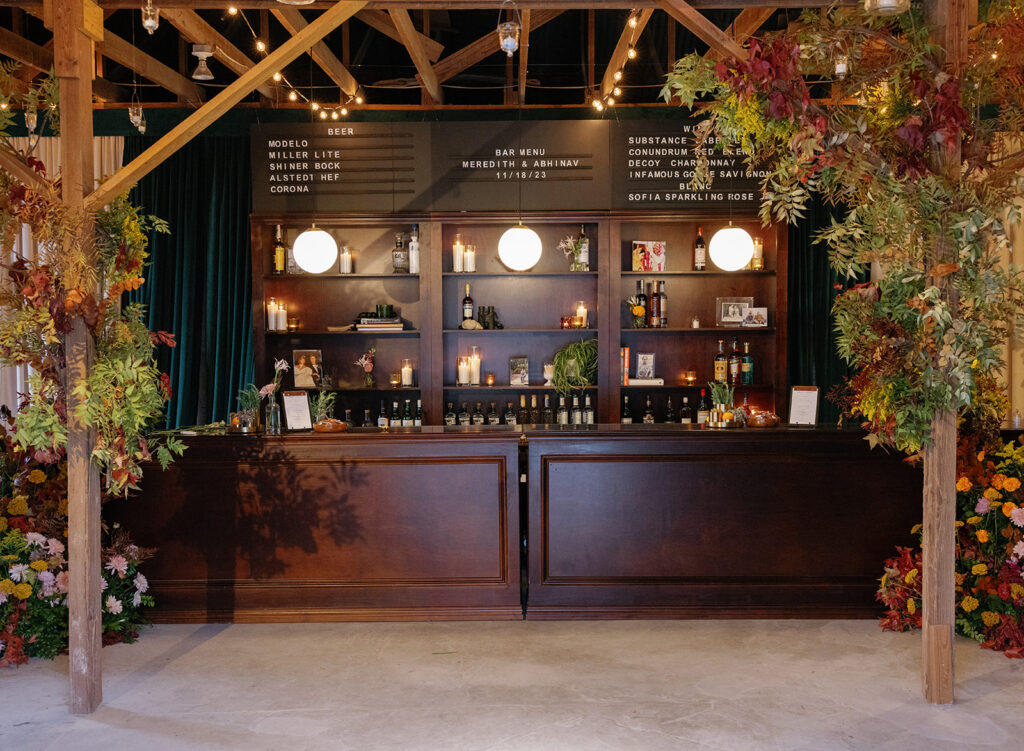 bar setup with greenery and florals at ranch wedding reception