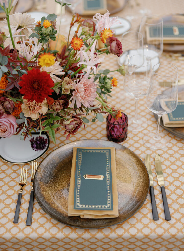 reception table with patterned linen and colorful florals