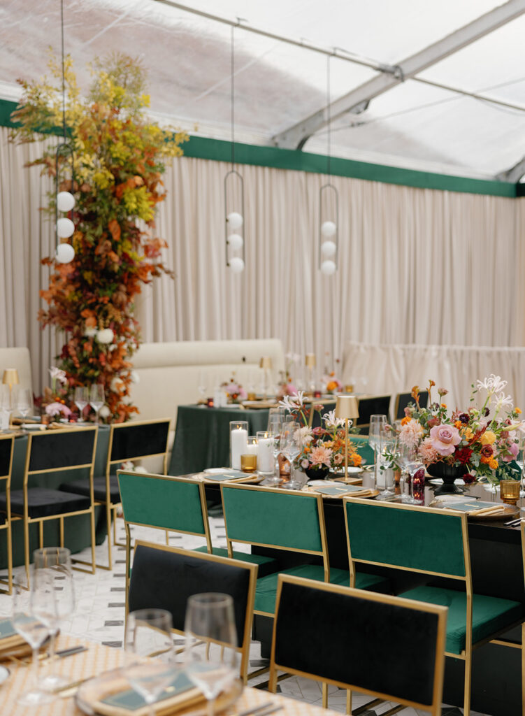 clear tent reception with green chairs at ranch wedding