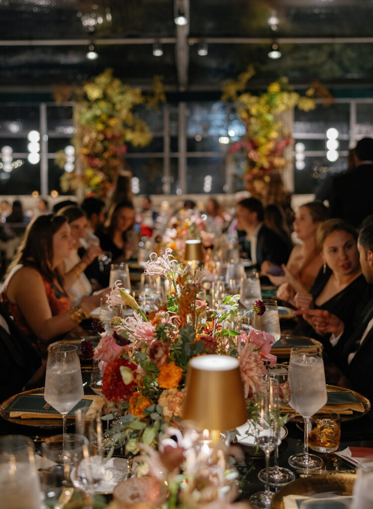 guests seated at long tables during evening reception