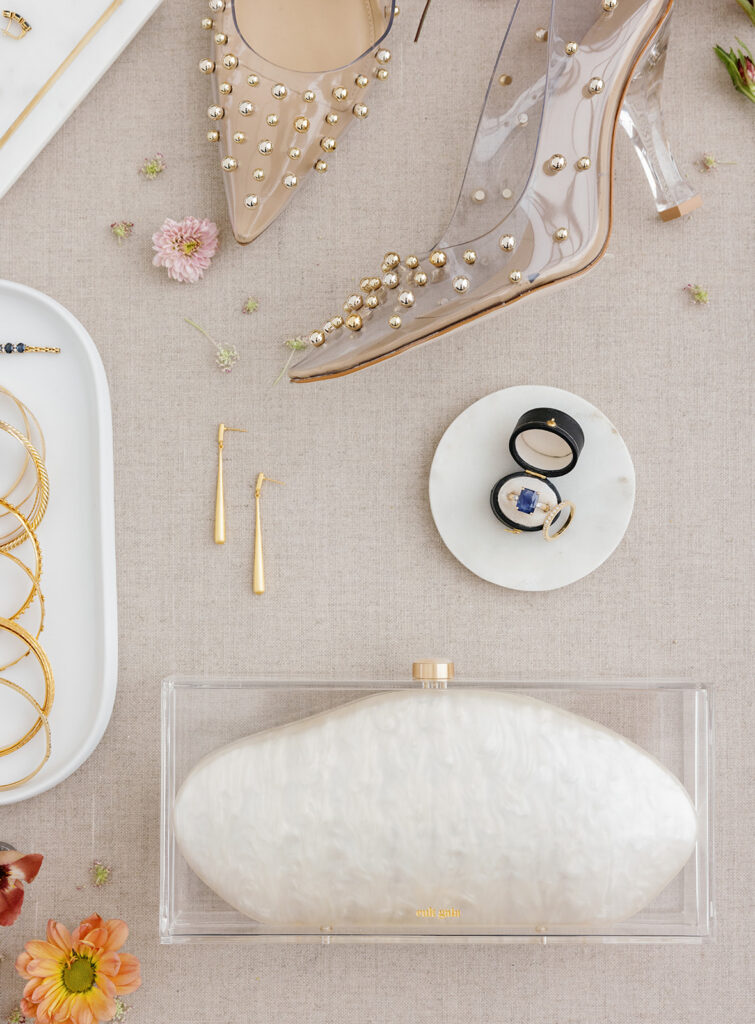 bridal shoes, jewelry, and clutch styled for wedding