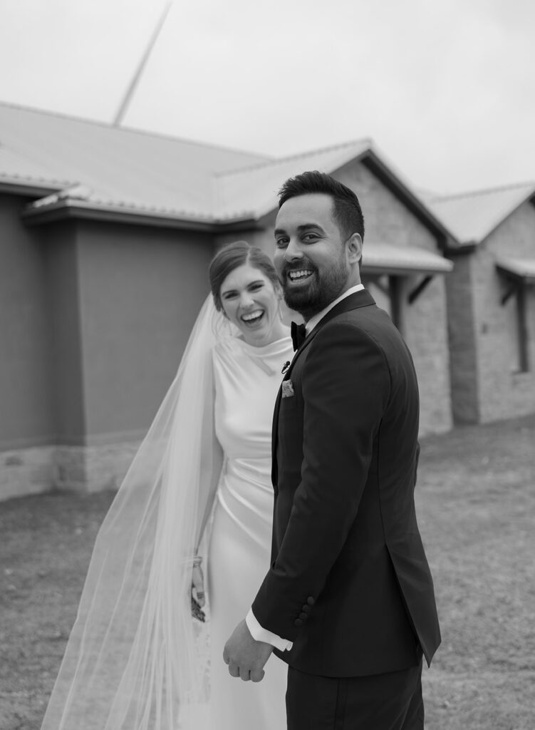 couple smiling during first look at ranch wedding