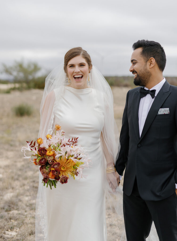 couple laughing during portraits at Texas ranch wedding
