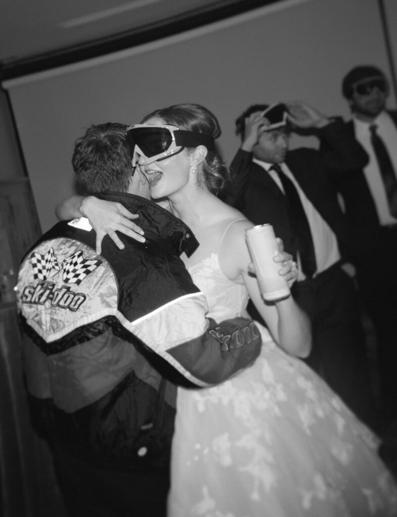 Bride hugging groom on dance floor during after party with fun styling and energetic atmosphere